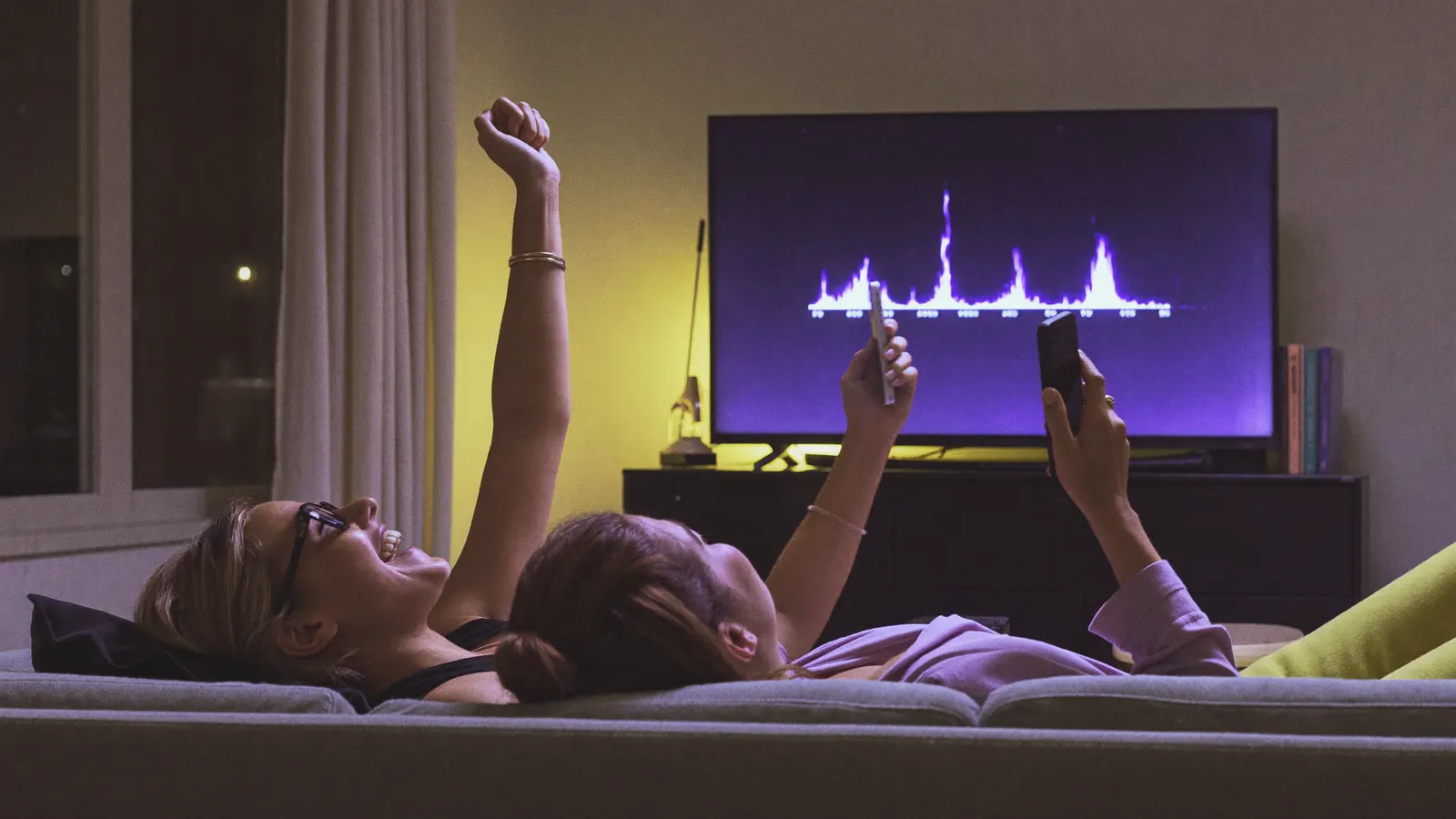 Friends on a couch reacting to a live leaderboard